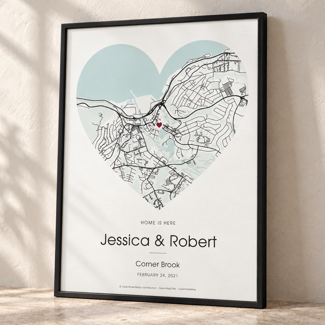 Pale blue heart-shaped map print in a black frame