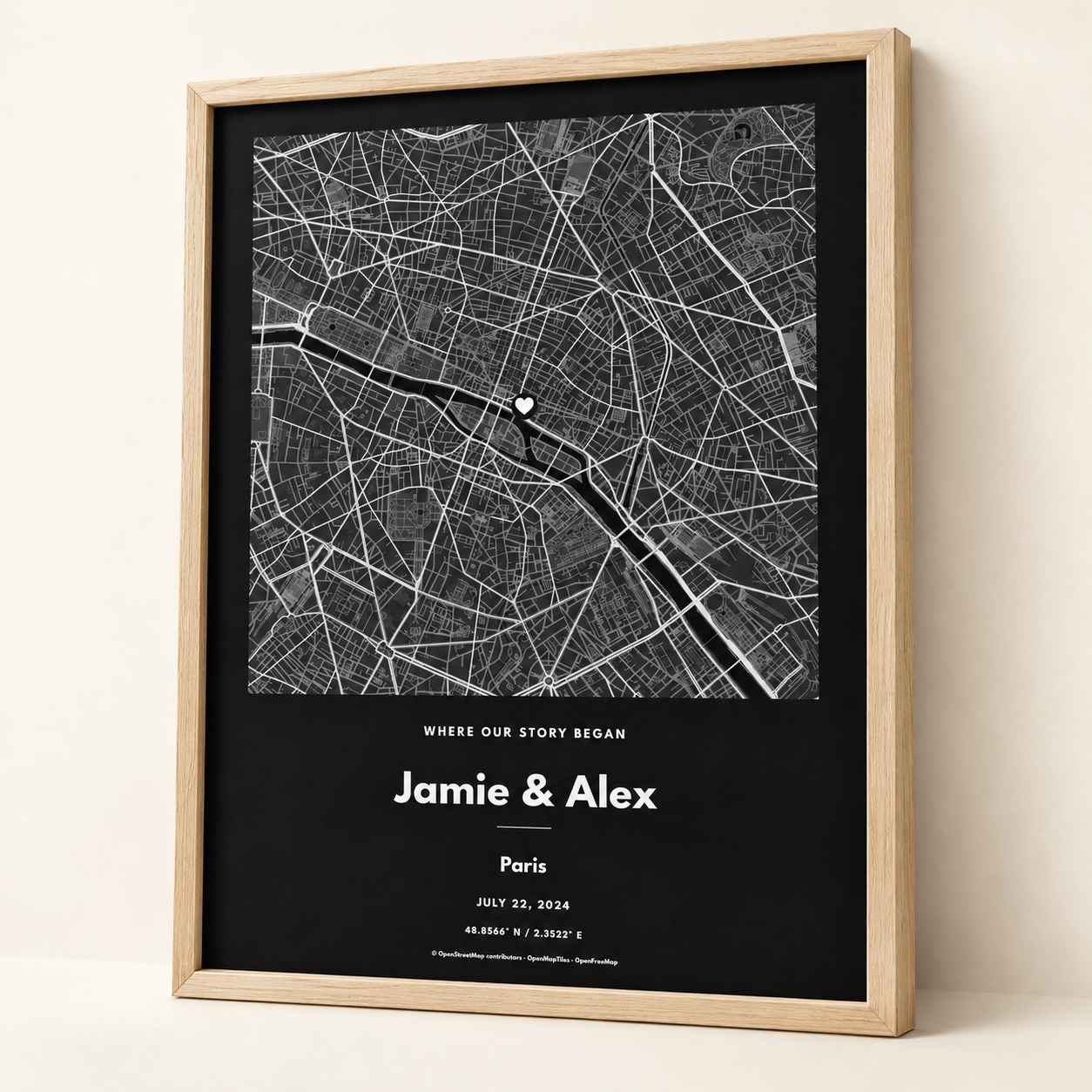 Dark monochrome map print in a light oak frame